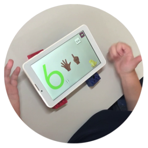 Close-up of hands and tablet with number activity on screen